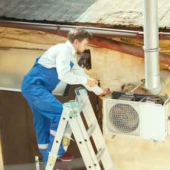 Technician cleaning air ducts inside O’Fallon commercial building