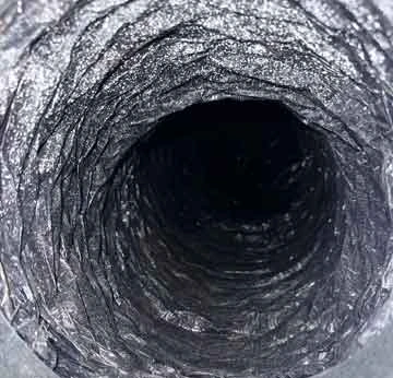 Lint-filled dryer vent compared to clean vent after professional service in O’Fallon