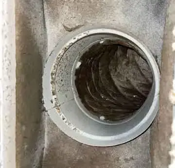 Comparison photo showing dryer vent obstruction before cleaning and clear airflow after service