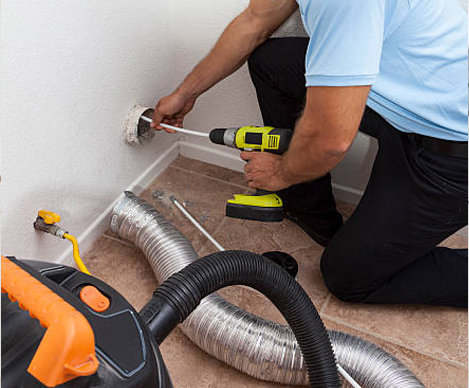 Show Me Air Duct Cleaning technician using vacuum hose to clean dryer vent in O’Fallon Missouri